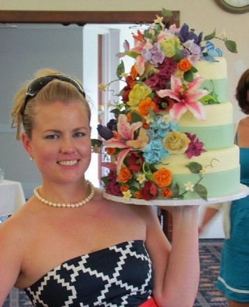 Kate holds a three-tiered cake